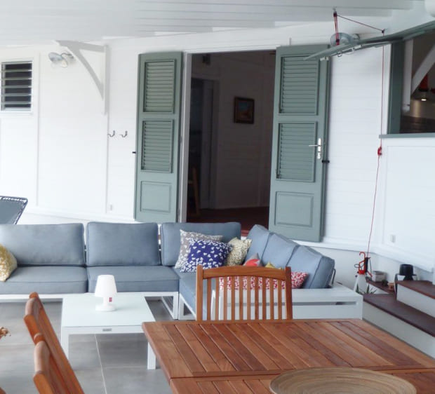 View of outdoor terrace with corner sofa, coffee table and dining table